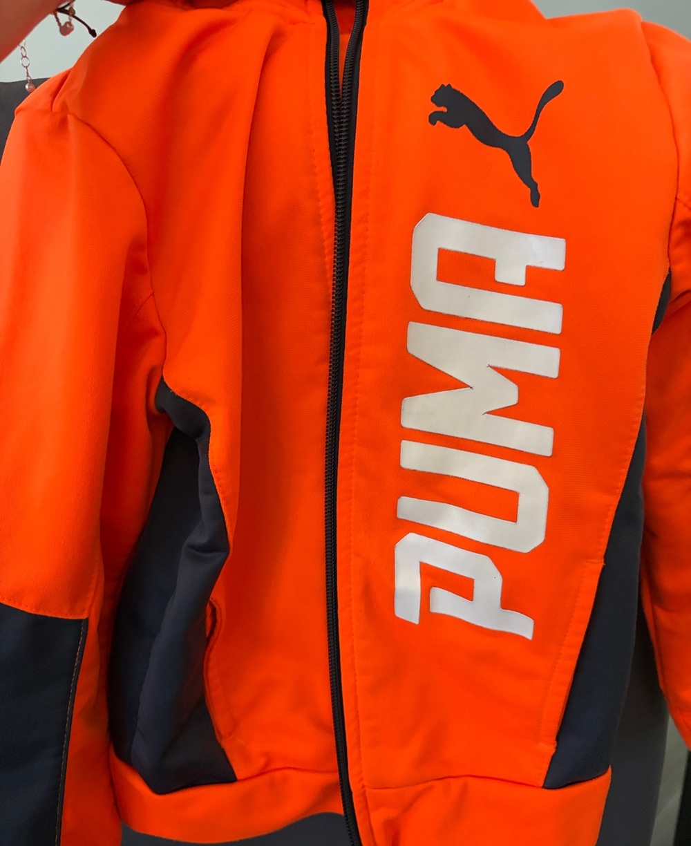 Puma kid’s Bright Orange Performance Jacket with Black Panels